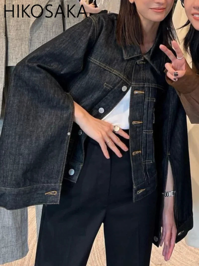 Person wearing a dark denim jacket with 'HIKOSAKA' branding.