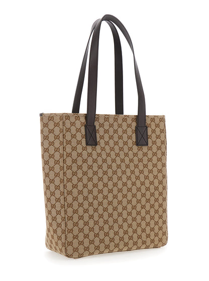 Beige tote bag with brown pattern and black handles on a white background