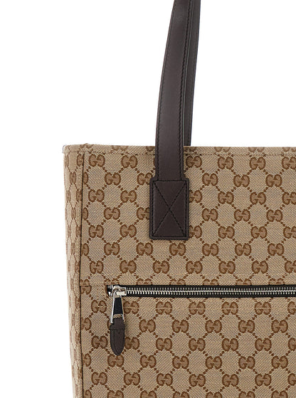 Beige handbag with brown handle and zipper on a white background