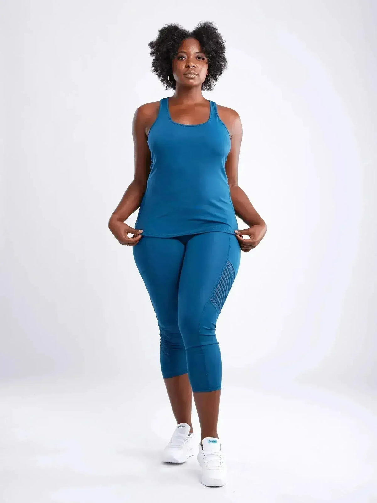Woman wearing a blue athletic outfit on a white background