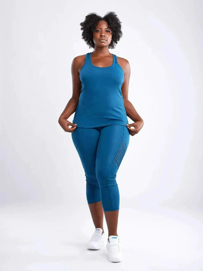 Woman wearing a blue athletic outfit on a white background