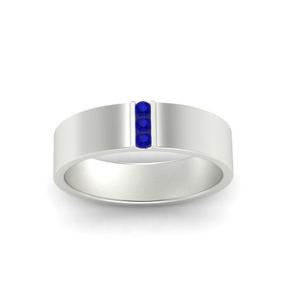 Silver ring with a blue gemstone on a white background