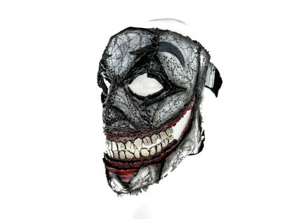Black and white mask with red accents on a white background