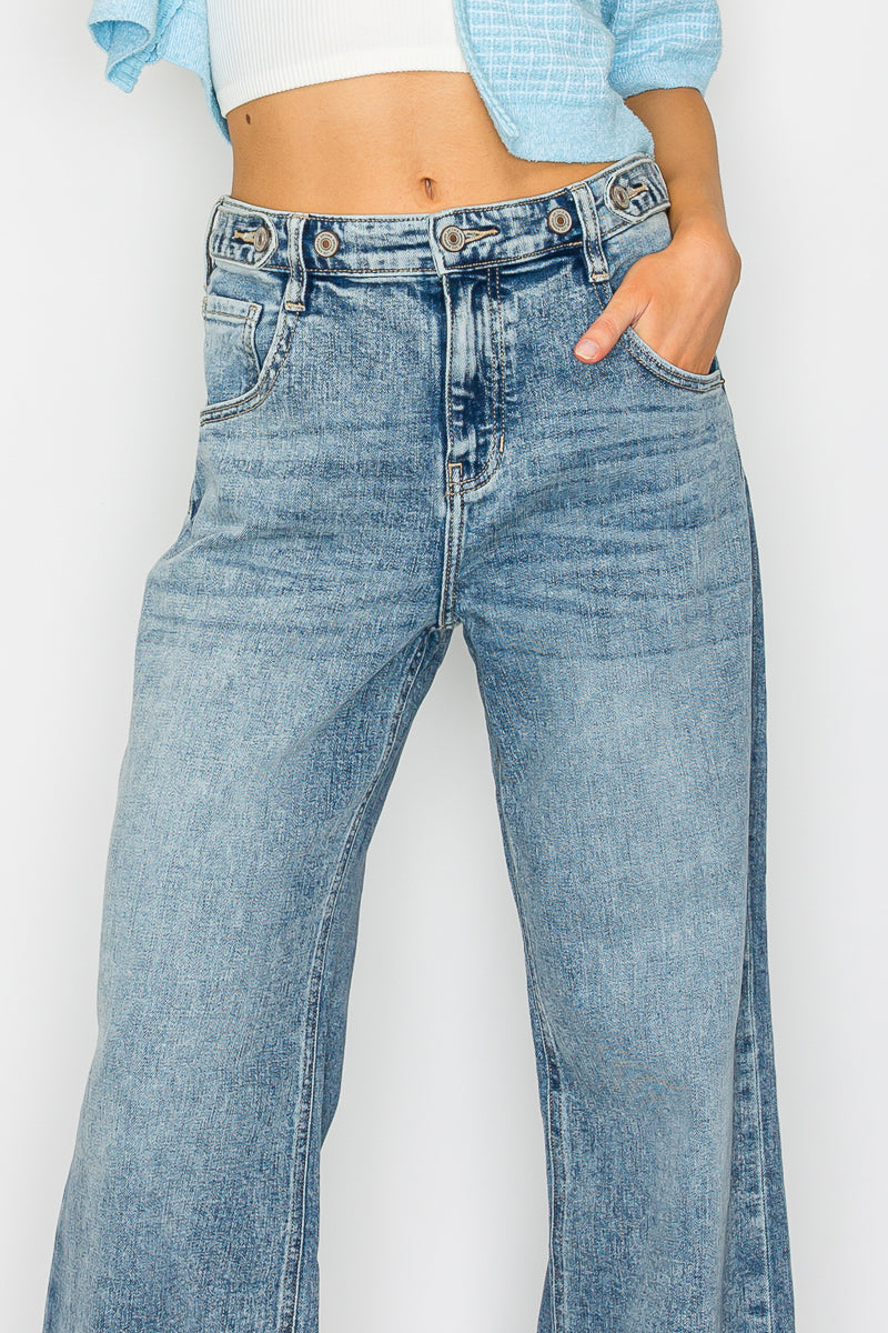 Person wearing light blue jeans on a white background