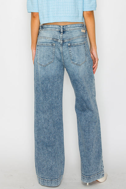 Person wearing light blue jeans and a matching top on a white background