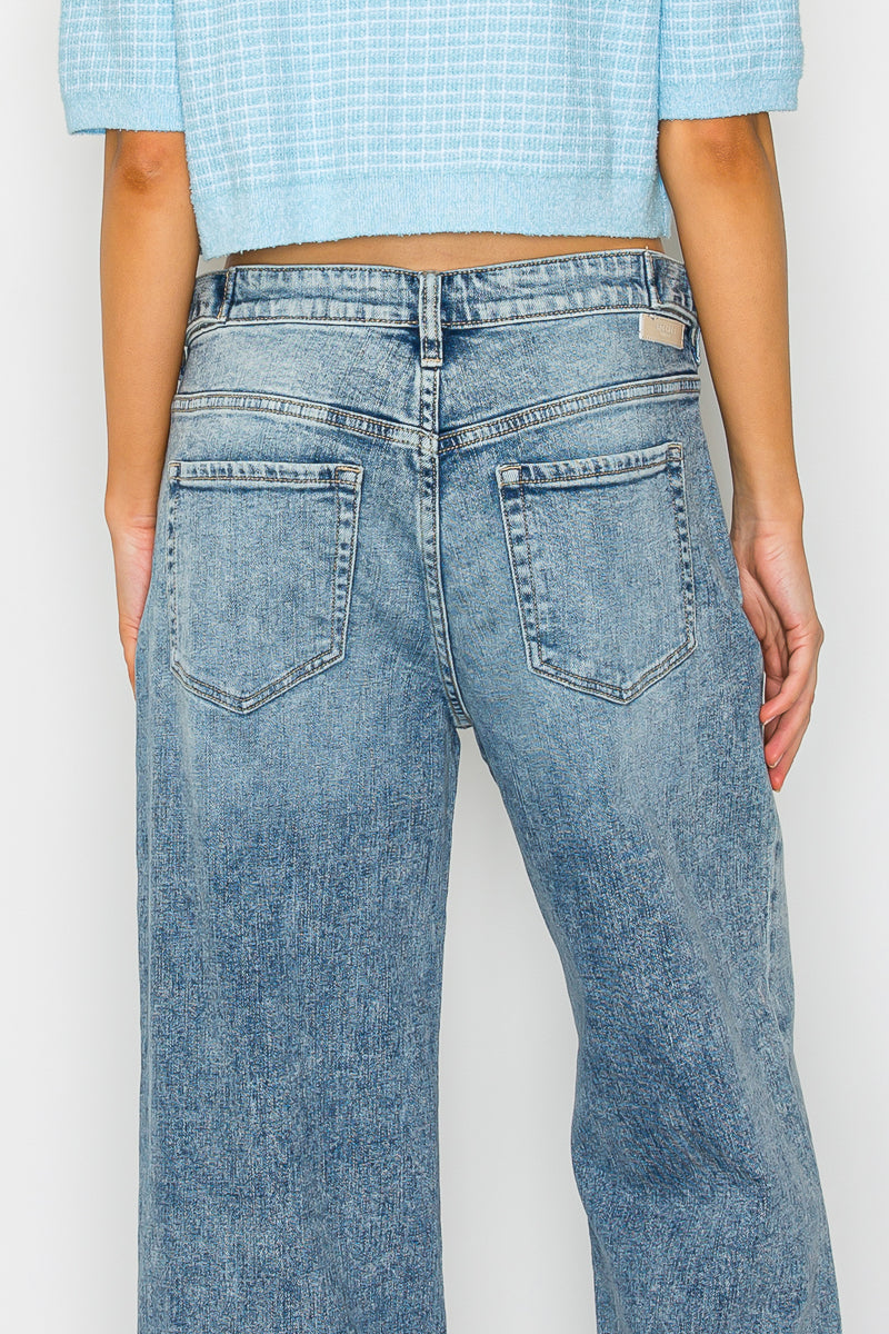 Light blue jeans worn by a person on a white background