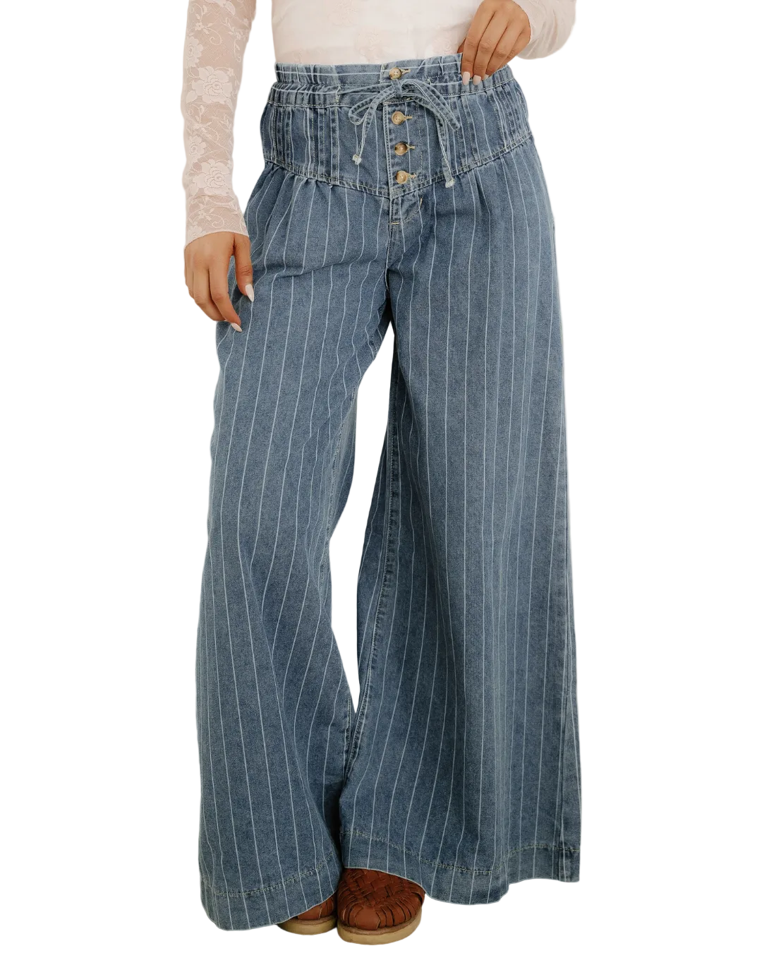 Person wearing blue pinstripe jeans against a white background