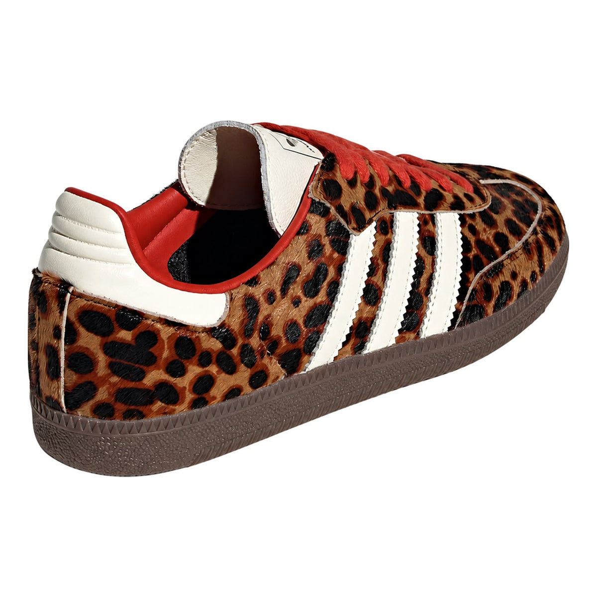 A low-top sneaker featuring a brown and black leopard print pattern, accented with white leather side stripes, a red collar lining, and a brown rubber sole.