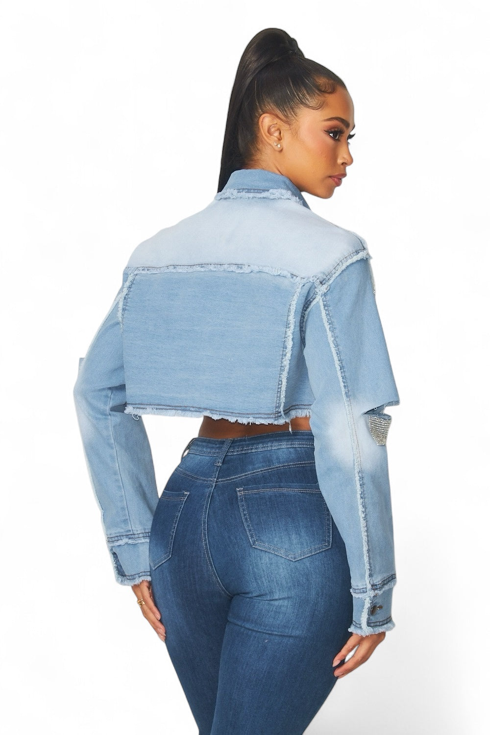 Person wearing a light blue denim jacket and jeans on a white background