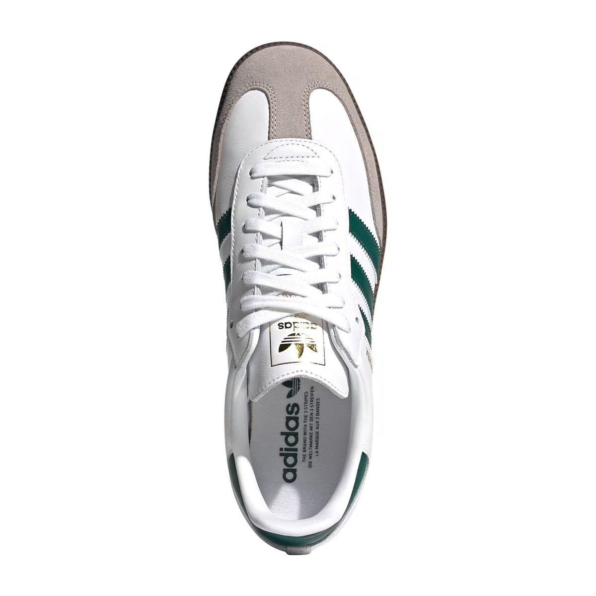 A top-down view of an Adidas Samba sneaker in white, taupe, and green, featuring white leather panels, a taupe suede toe cap, and green stripes on a white background.
