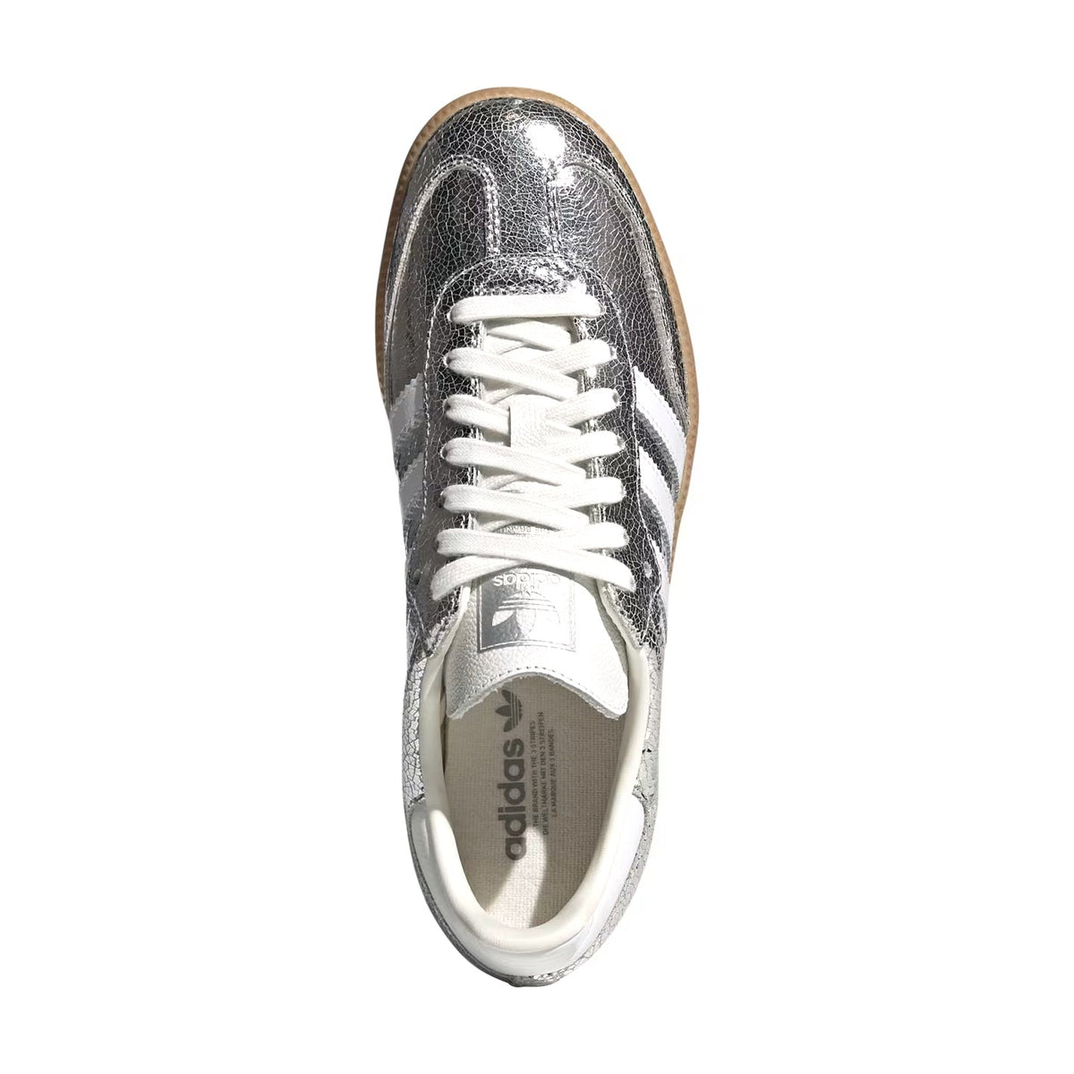 A single Adidas Samba sneaker in metallic silver with white laces and white side stripes, photographed from a top-down perspective on a white background.