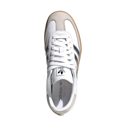 A single Adidas Samba sneaker shown from a top-down view on a solid white background. The shoe features a white leather upper, a beige suede toe cap, dark gray three stripes, a white laces, and a brown gum sole.