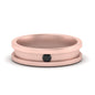 Rose gold metal ring with a black center on a white background