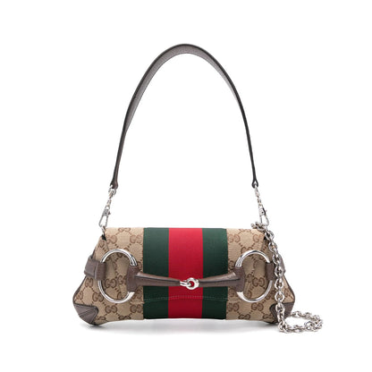 Designer handbag with a distinctive strap on a white background