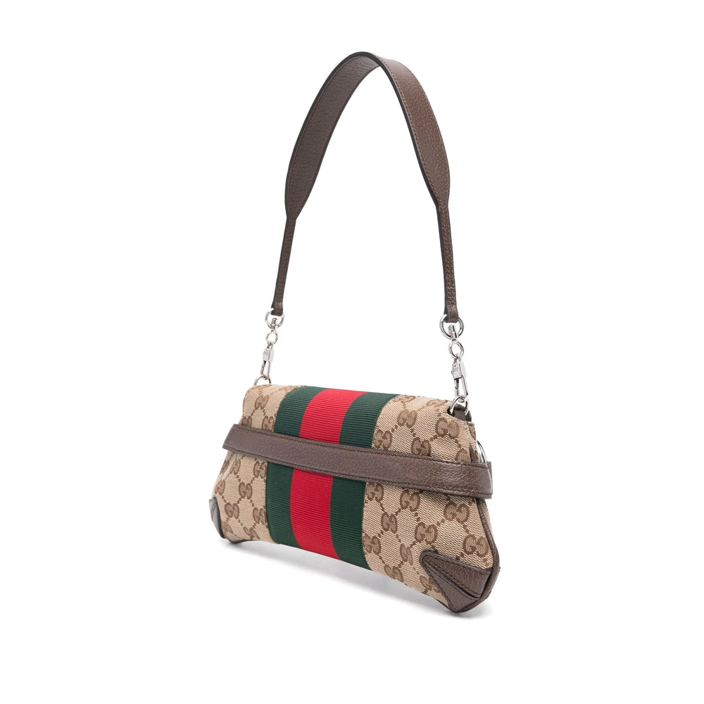 Designer handbag with beige fabric and brown leather accents on a white background