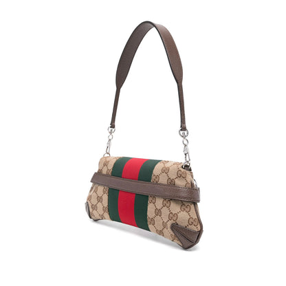 Designer handbag with beige fabric and brown leather accents on a white background