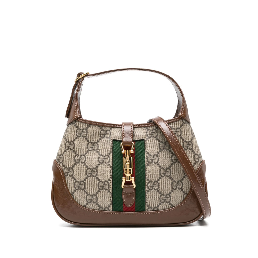 Designer handbag with patterned fabric and brown leather accents on a white background