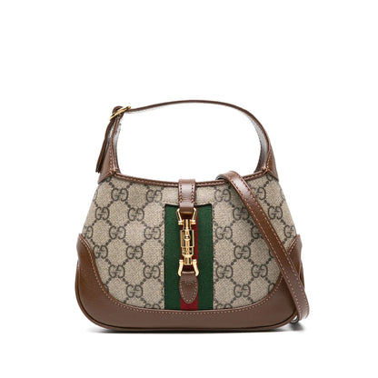 Designer handbag with patterned fabric and brown leather accents on a white background