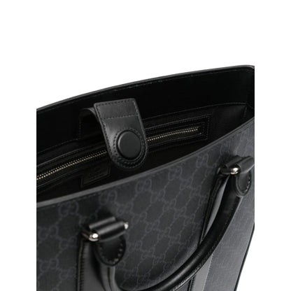Black handbag with a patterned design on a white background