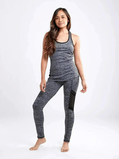 Woman wearing a gray athletic outfit on a white background