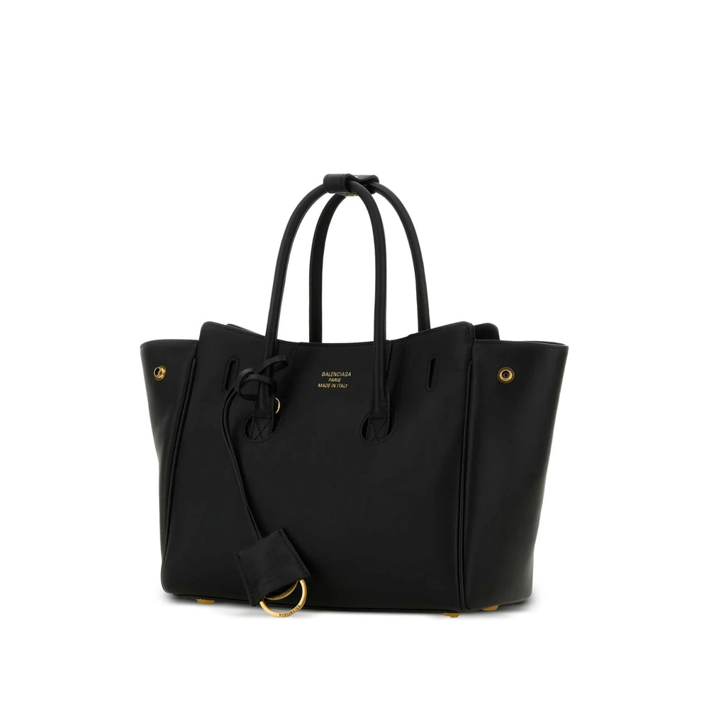 Black handbag with gold accents on a white background