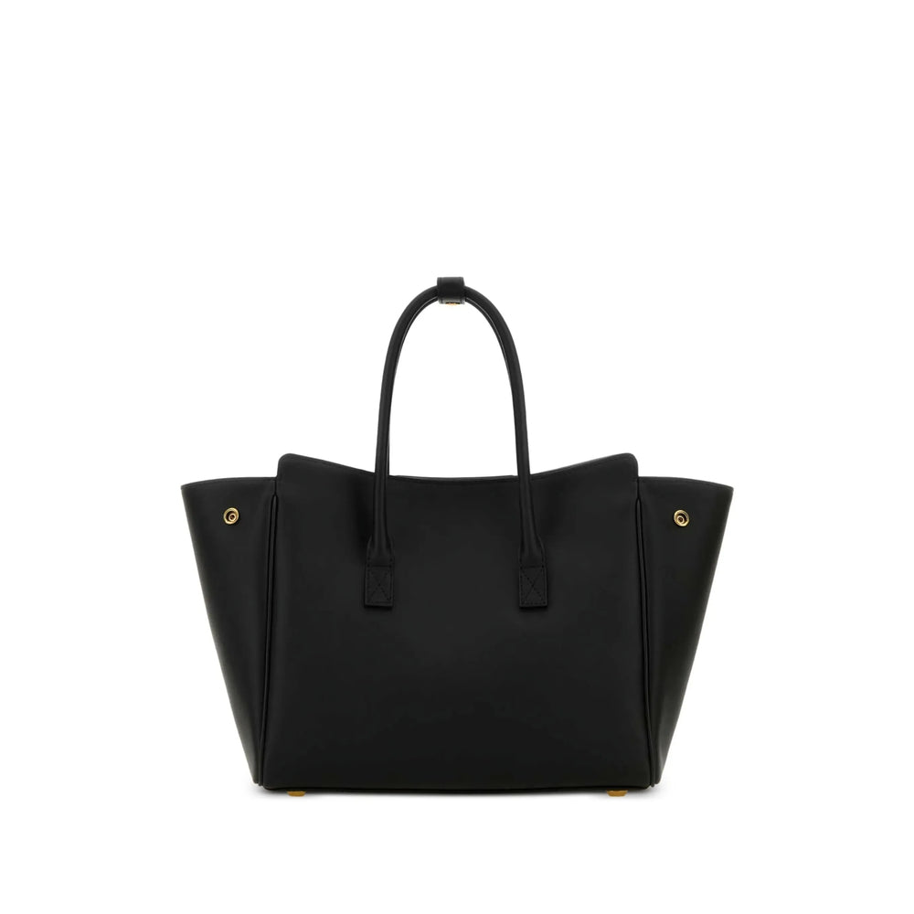 Black handbag with gold hardware on a white background