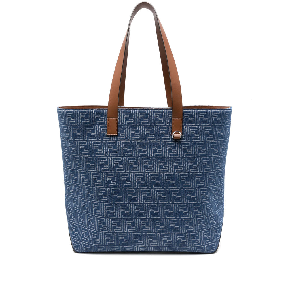 Blue tote bag with brown handles on a white background