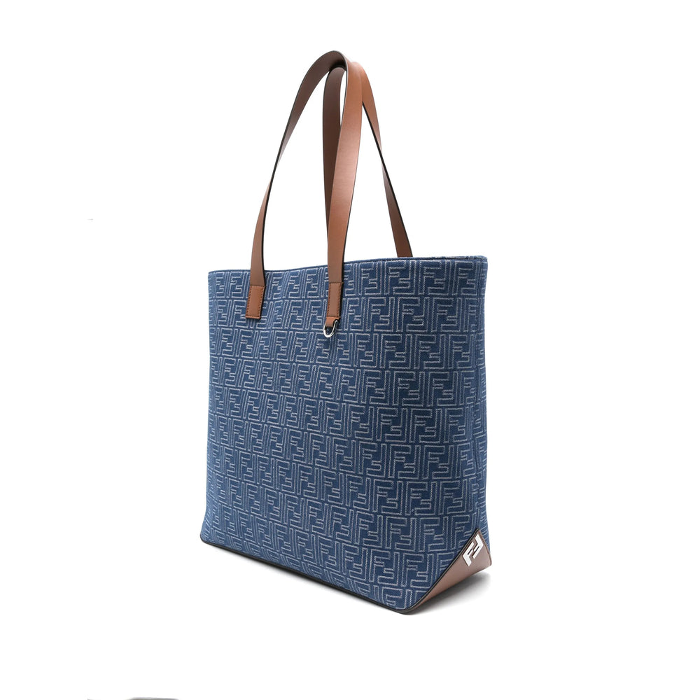 Blue tote bag with brown handles on a white background