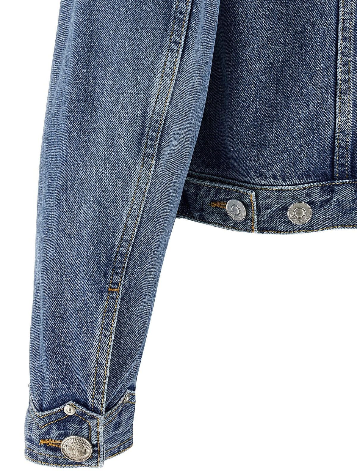 Close-up of a blue denim jacket with button details on a white background