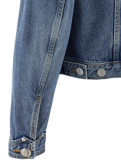 Close-up of a blue denim jacket with button details on a white background