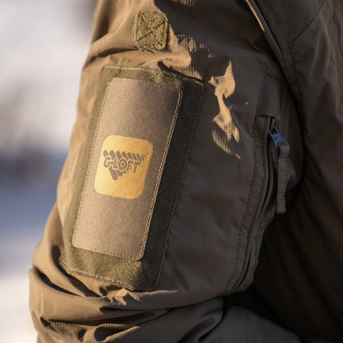 Close-up of a jacket with a Gloft patch on a blurred background