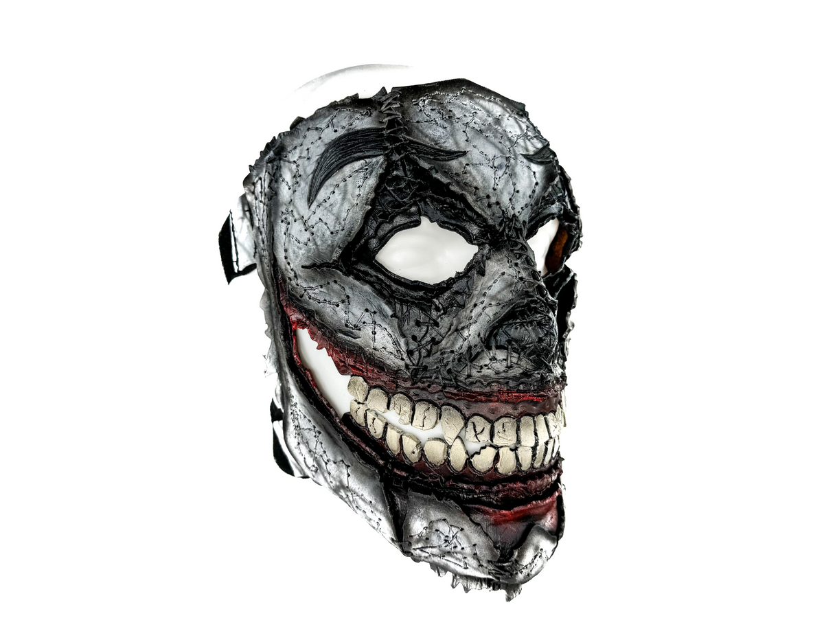 Detailed mask with a textured surface and red accents on a white background