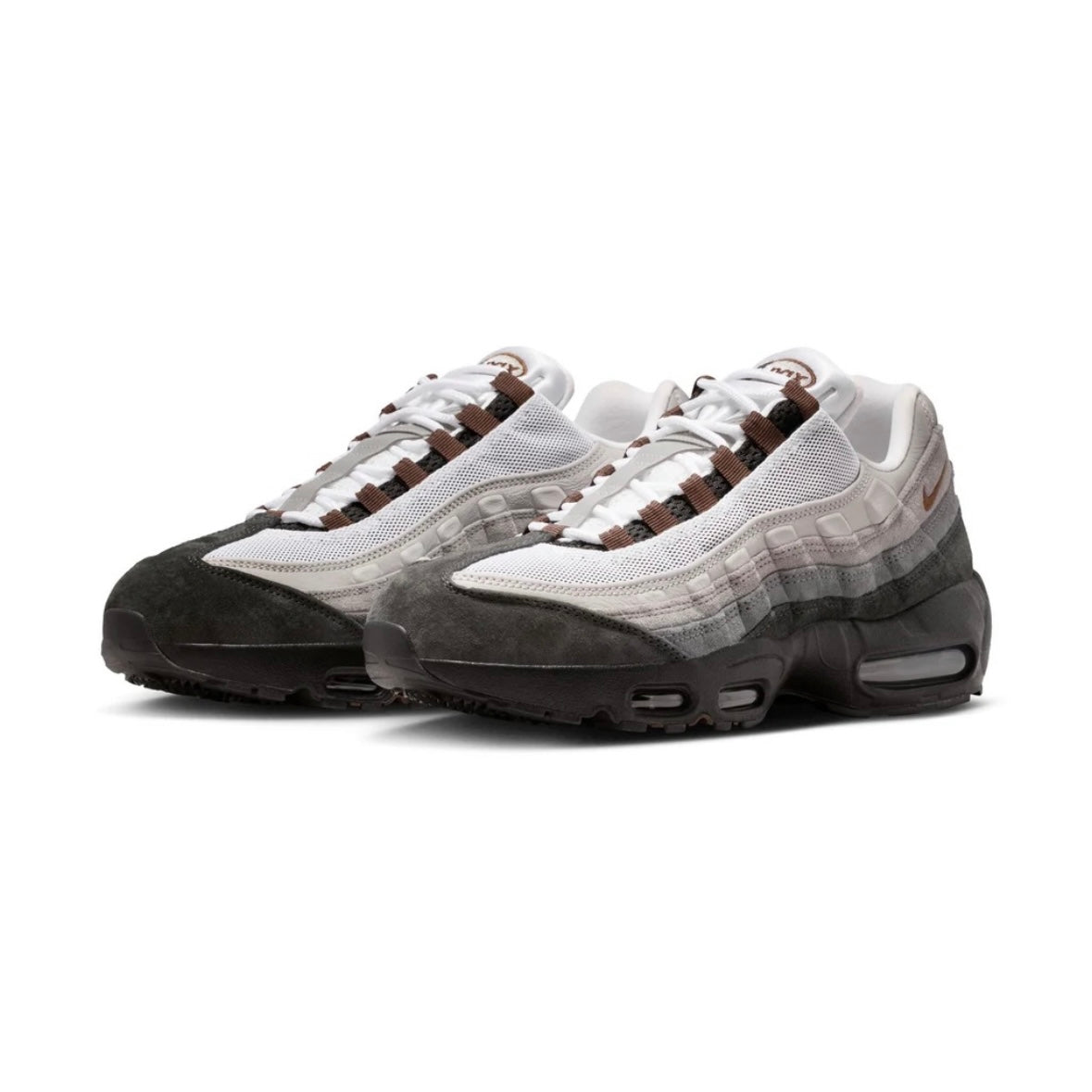 A pair of Nike Air Max 95 sneakers in a white, gray, and brown colorway, featuring a mesh upper, suede toe cap, and gradient midsole, shown against a plain white background.