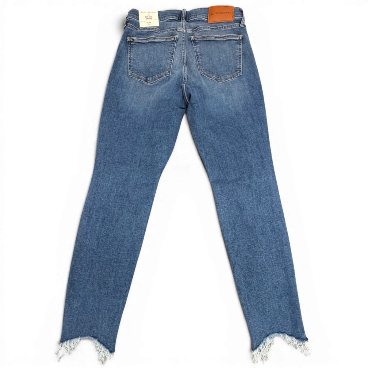 Blue jeans with frayed hems on a white background