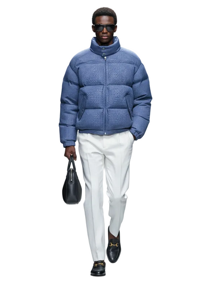 Man wearing a blue puffer jacket on a runway