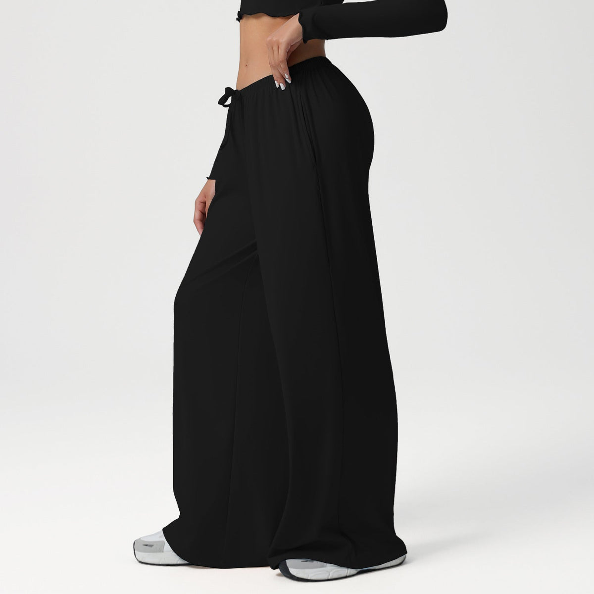Black wide-leg pants worn by a person on a white background