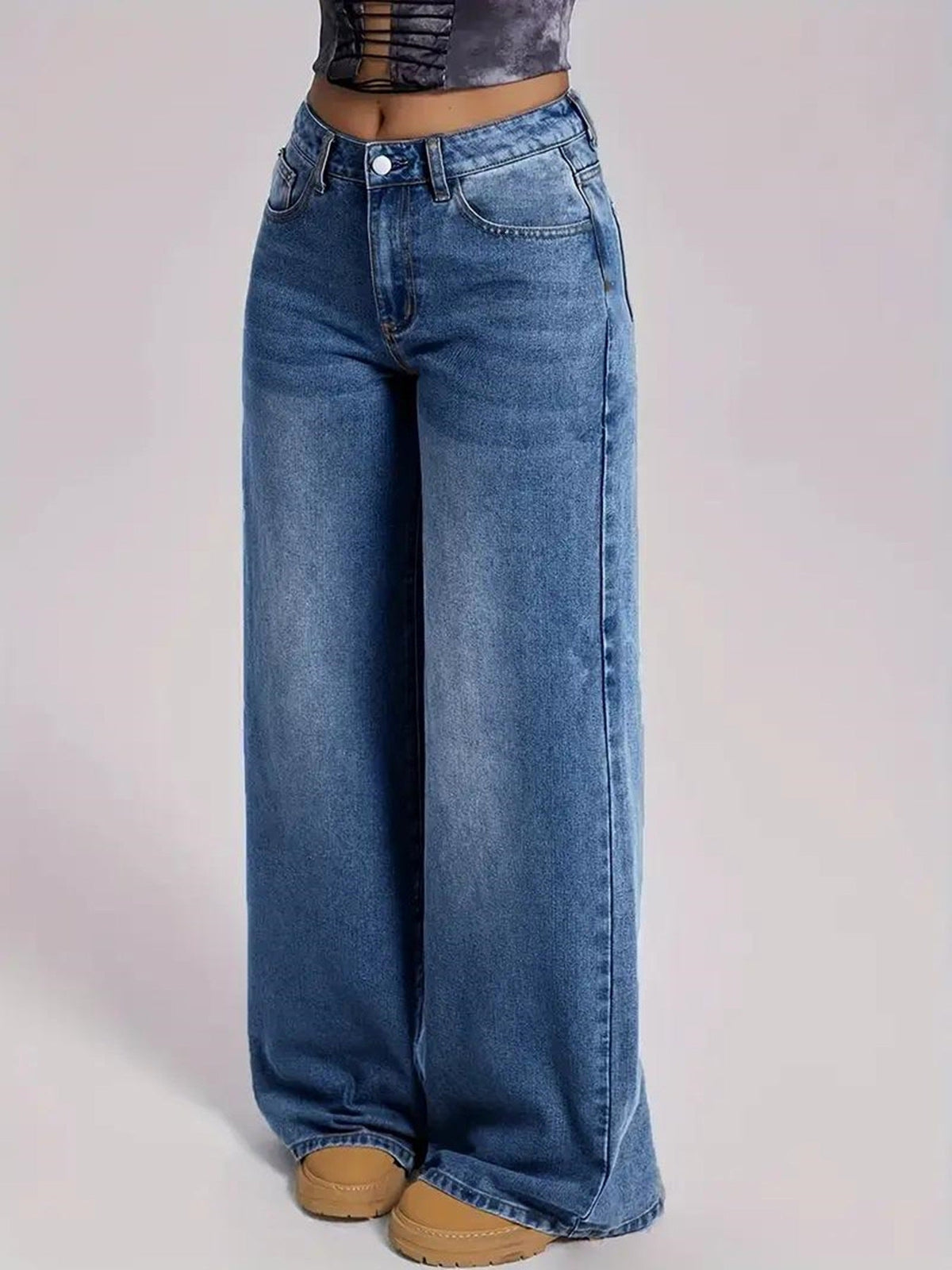 Wide-leg jeans worn by a person on a light gray background