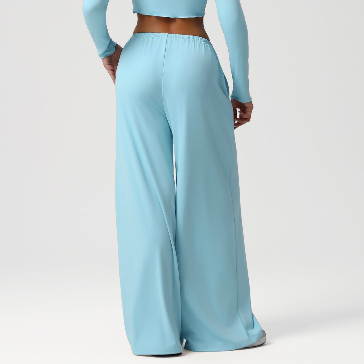 Light blue long-sleeve top and wide-leg pants on a white background