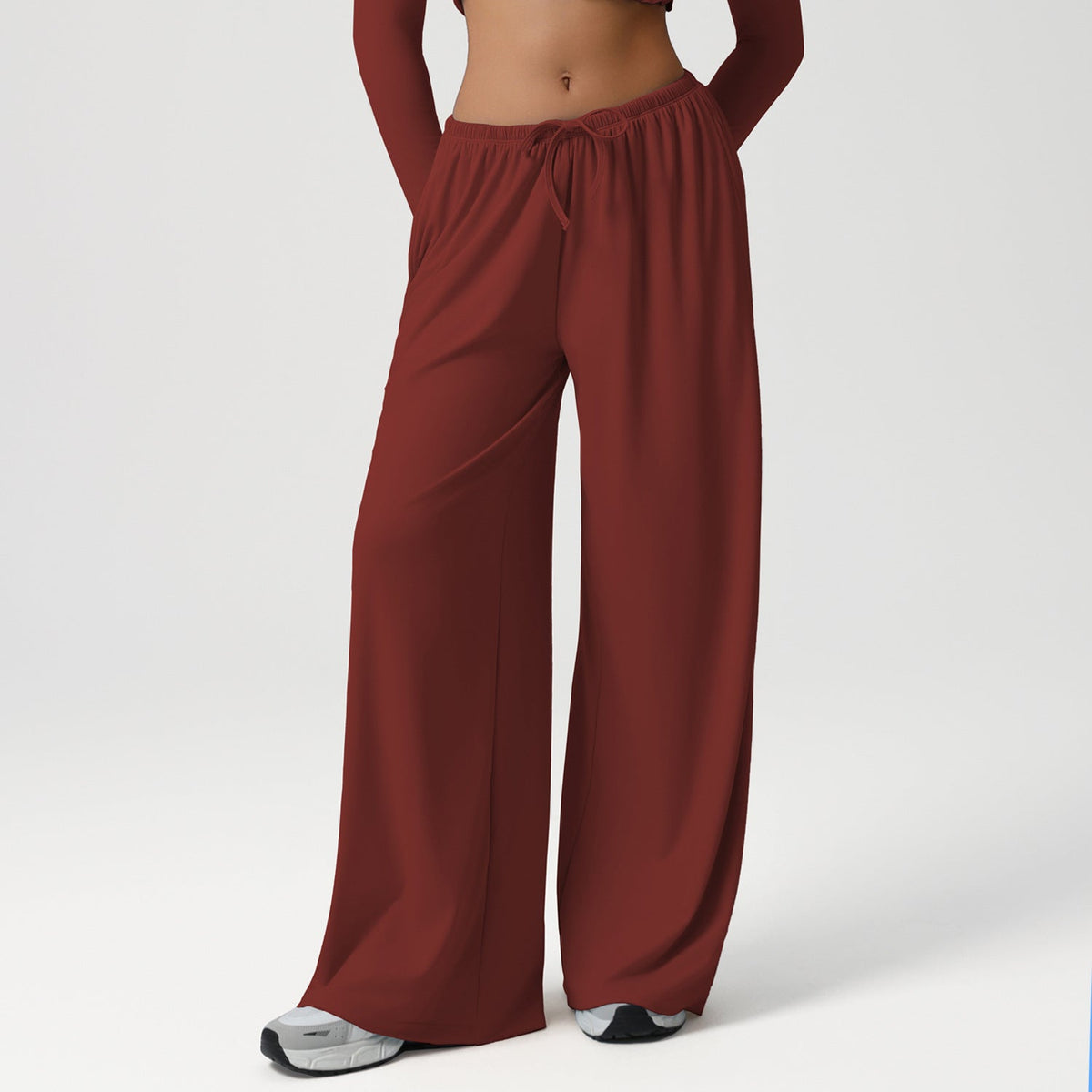 Maroon wide-leg pants worn by a person on a white background
