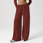 Maroon wide-leg pants worn by a person on a white background
