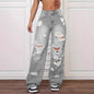 Person wearing gray distressed jeans on a white background