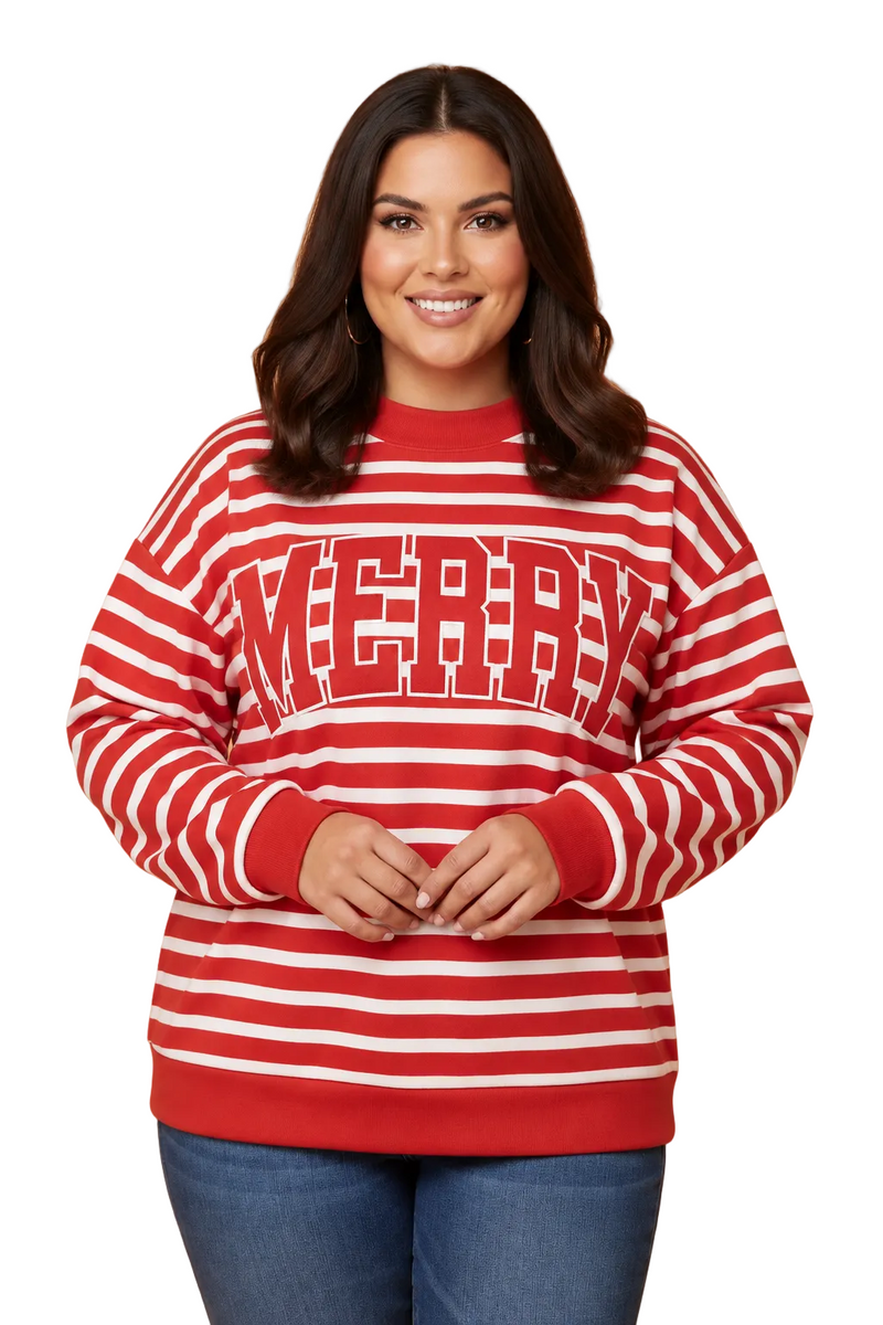 A woman modeling a red and white horizontally striped crewneck sweatshirt with 'MERRY' printed across the chest in large red block letters, paired with blue jeans against a solid tan studio background.