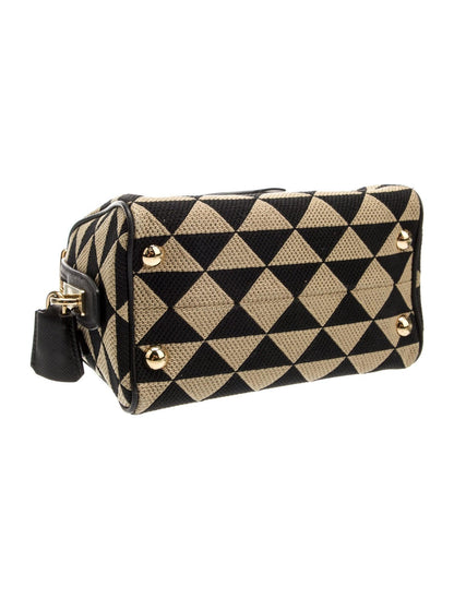 Black and beige patterned wallet with gold accents on a white background