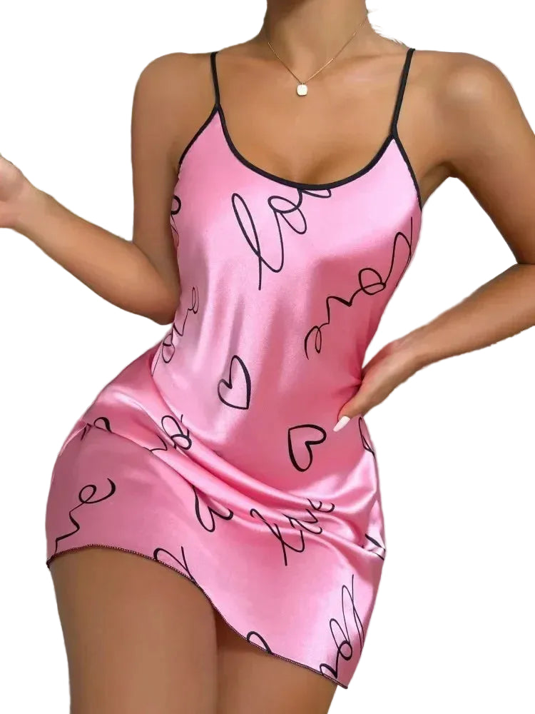 Pink satin nightgown with heart and 'love' patterns worn by a person.