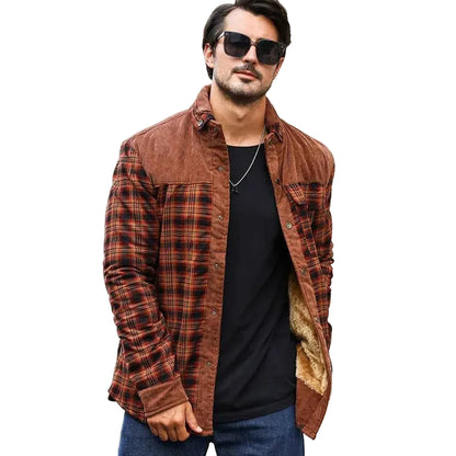 Man wearing a brown plaid shirt over a black t-shirt with sunglasses indoors.