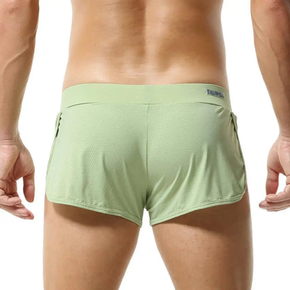 Green athletic shorts with a brand logo on a white background
