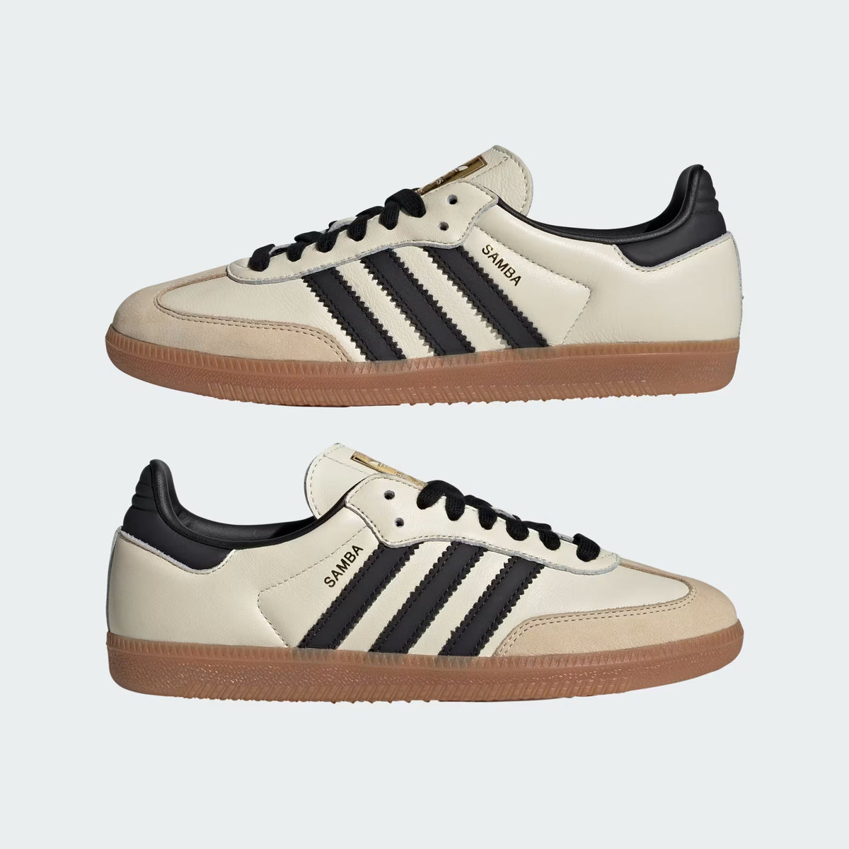 Pair of beige sneakers with black stripes and brown soles on a white background