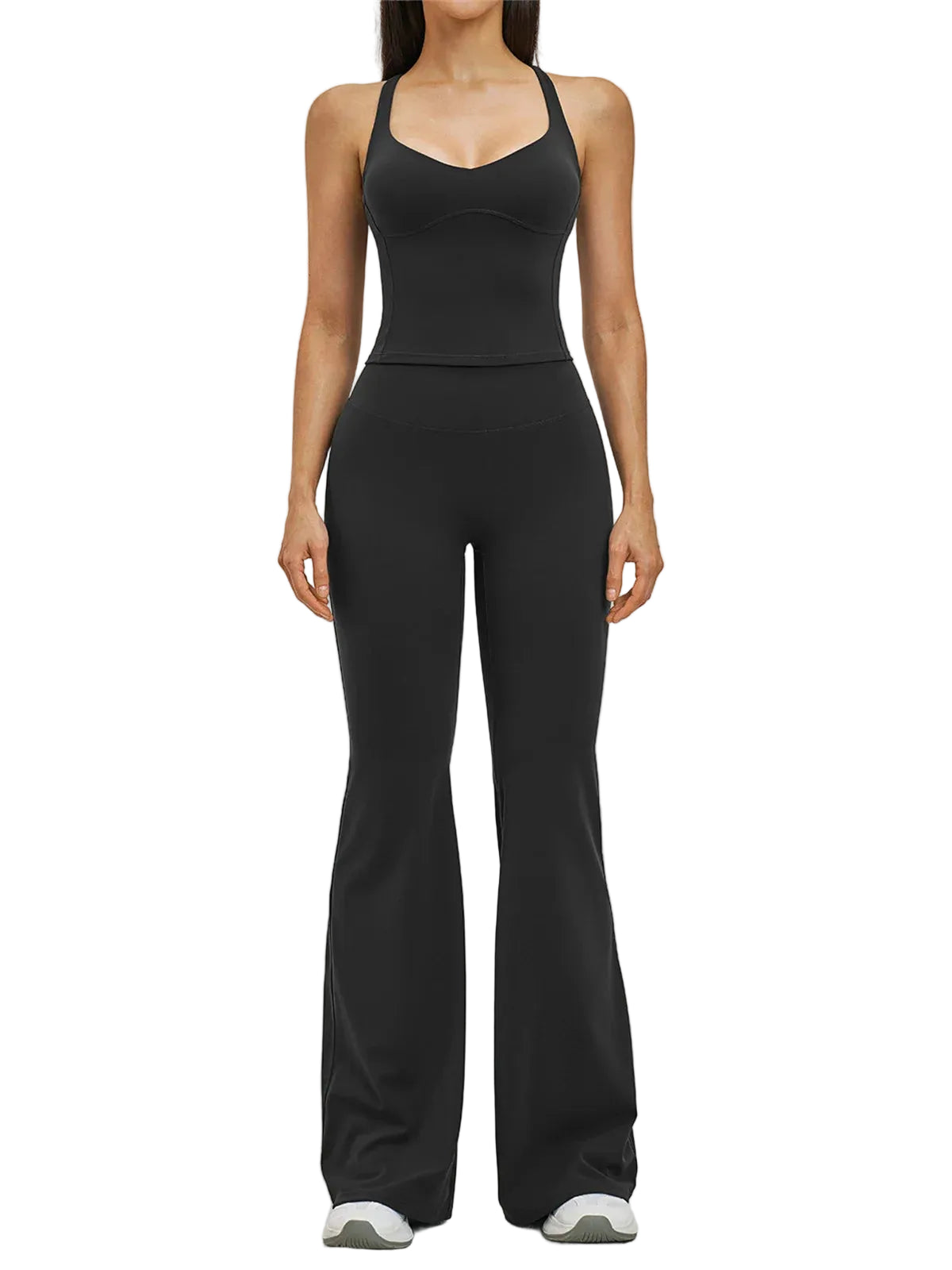 A woman modeling a black sleeveless one-piece jumpsuit with a fitted bodice and wide-leg flared pants, photographed against a light gray studio background.