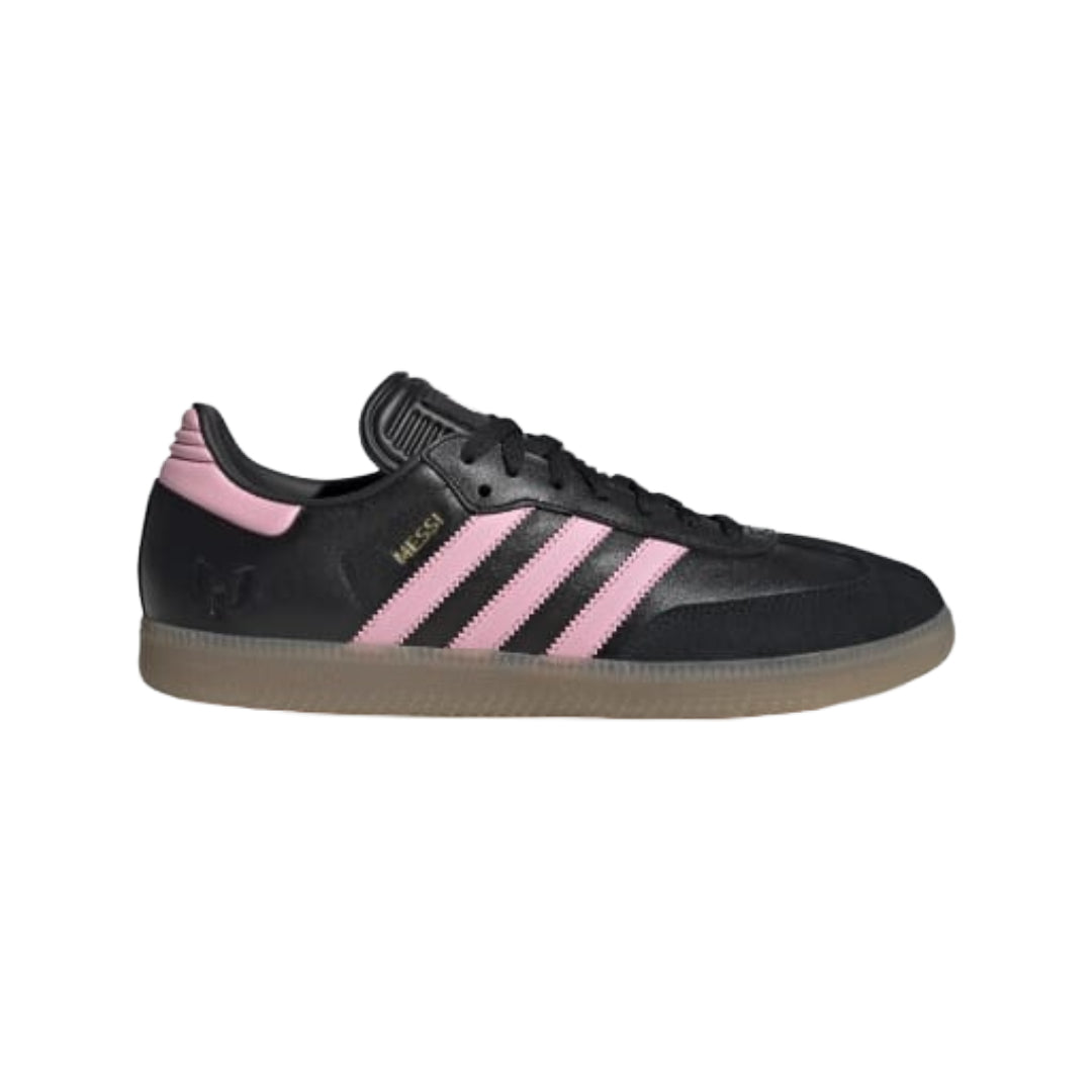A black Adidas Samba sneaker with pink three-stripes and a pink heel tab, shown in a side profile on a white background.