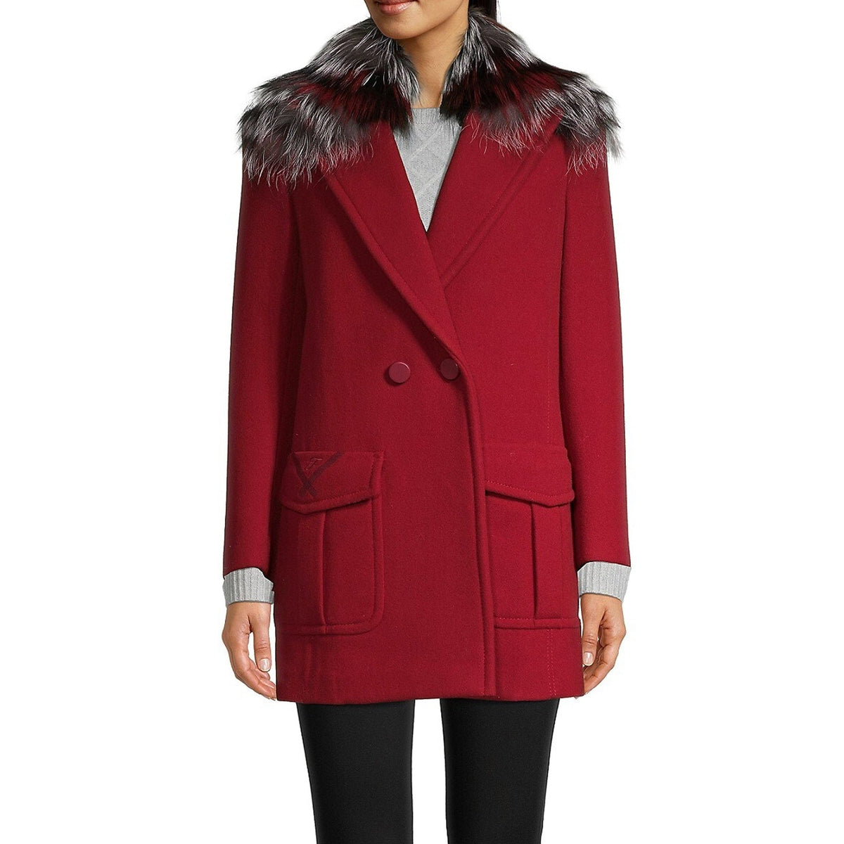 Red coat with fur collar worn by a person on a white background